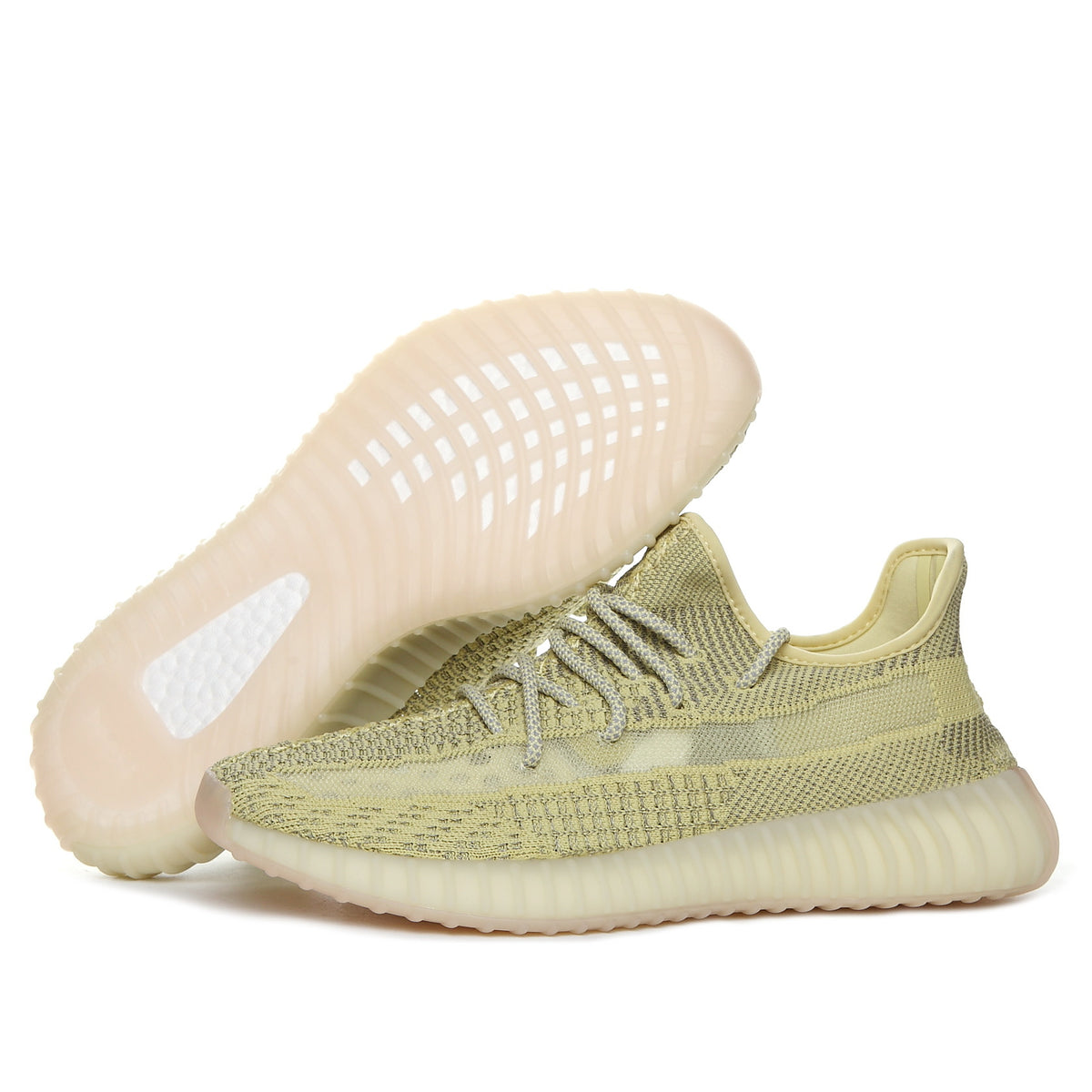 Side view of olive green Yeezy 350 V2 sneakers with one shoe lifted to show the translucent outsole.