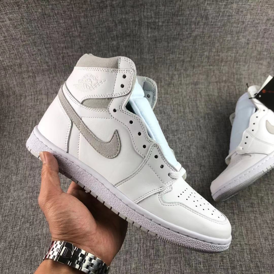 Single white and grey high-top sneaker held at an angled side view.