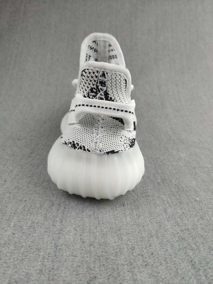 Front view showing the rounded toe, patterned knit upper, laces, and translucent sole.