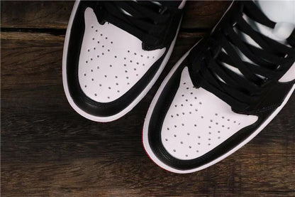 Top view of the perforated white toe boxes framed by black overlays.