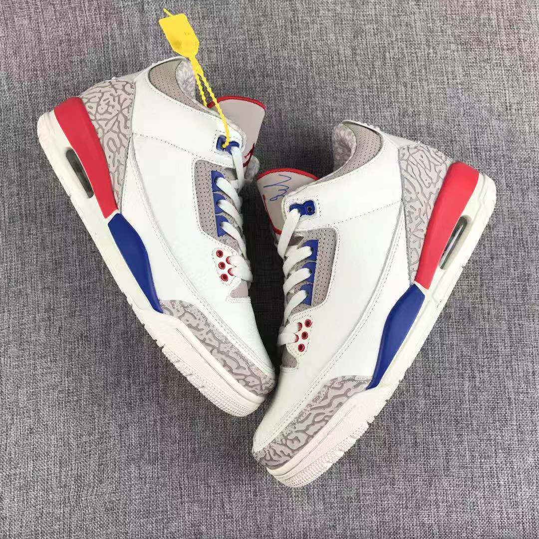 Side view of the pair showing the high-top profile, patterned grey panels, red heel sections, and blue midsole accents.