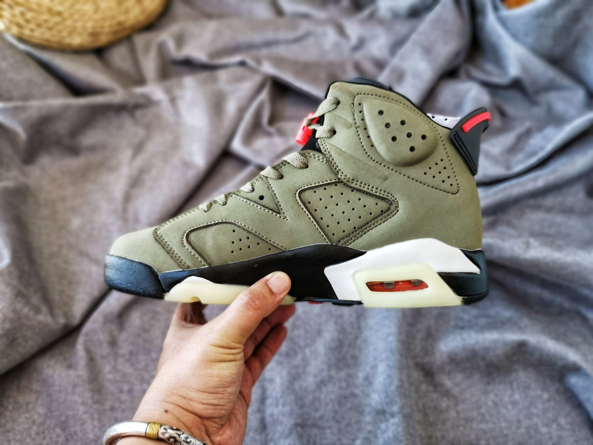 Side view of the sneaker highlighting the perforated upper panels, ankle detail, and translucent outsole.