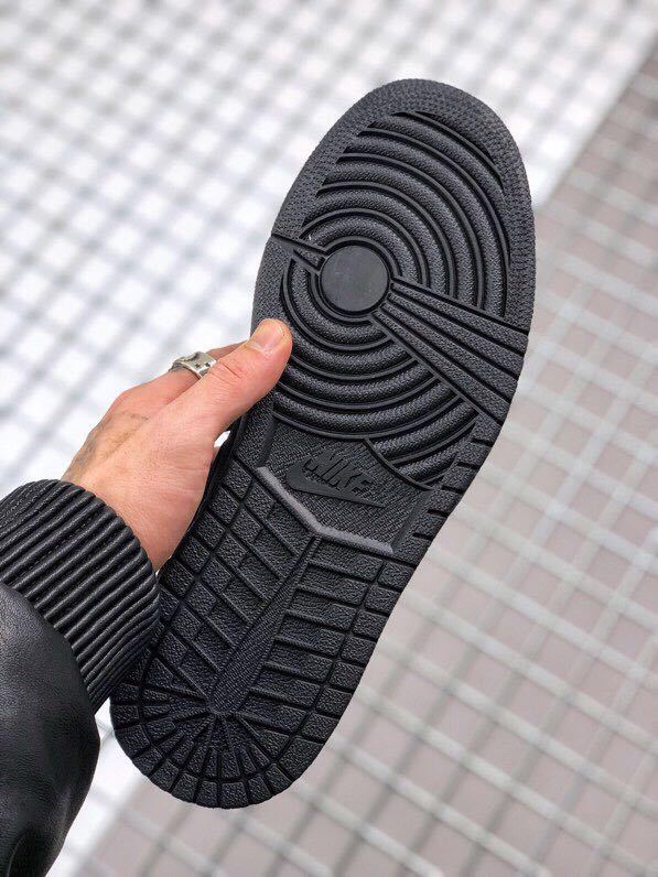 Bottom view of the black rubber outsole showing circular and geometric traction patterns.