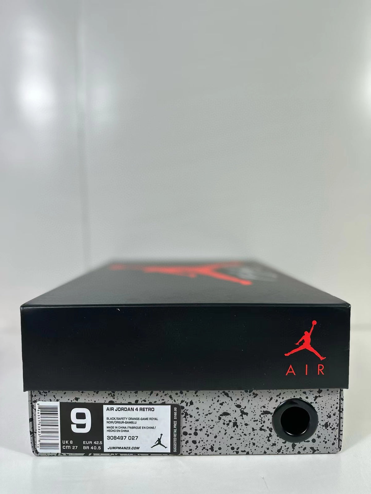 Jordan shoebox with a label showing Air Jordan 4 Retro, style code 308497-027 and sample size details.