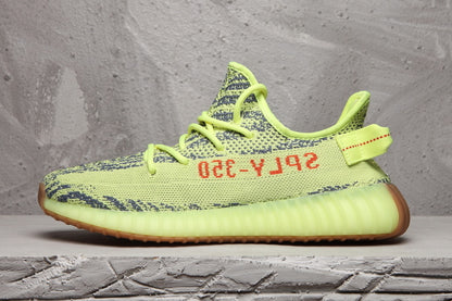 Side profile highlighting the lime green upper, dark knit pattern, translucent ribbed midsole, and gum outsole.