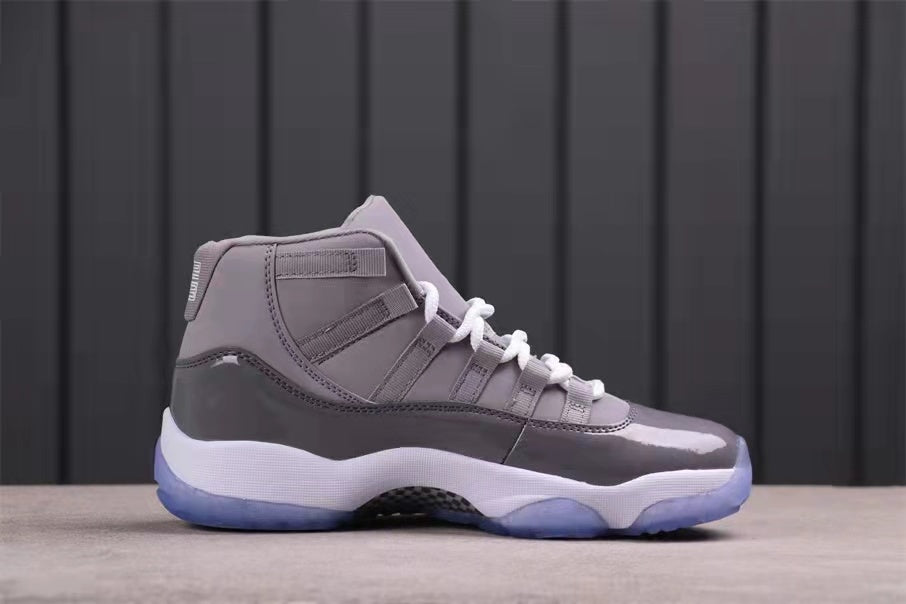 Side profile of a grey high-top sneaker with white midsole, translucent blue outsole, and layered upper panels.