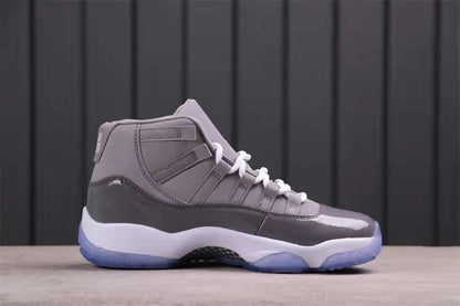 Side profile of a grey high-top sneaker with white midsole, translucent blue outsole, and layered upper panels.