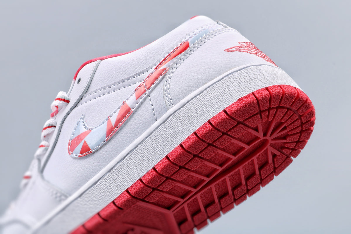 Angled view of the patterned side swoosh, white midsole, and red outsole tread.
