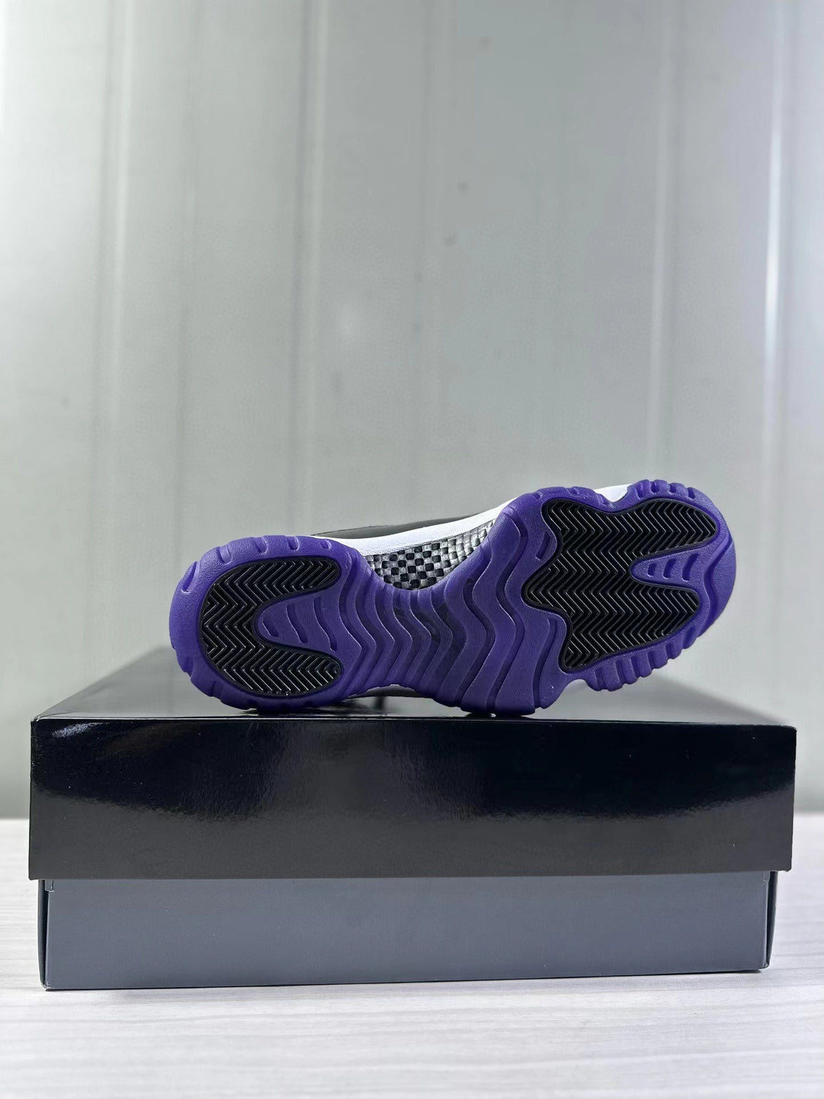 Bottom view showing the purple rubber outsole with black traction sections.