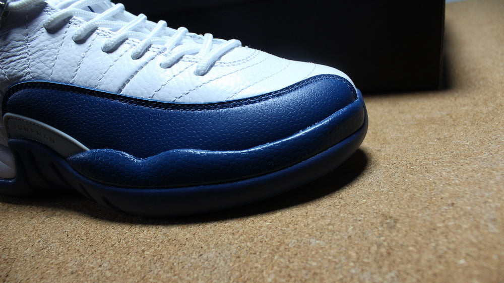 Close-up of the navy toe overlay and white stitched toe panel.