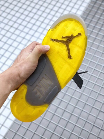 Underside view showing the yellow translucent outsole and traction pattern.