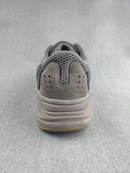 Rear view showing the padded heel, perforated heel panel, and stacked sole design.