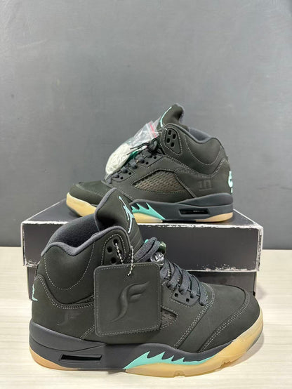 Close angled view of the Jordan Air Jordan 5 pair showing the padded collars, lace areas, hangtags, and aqua midsole details.