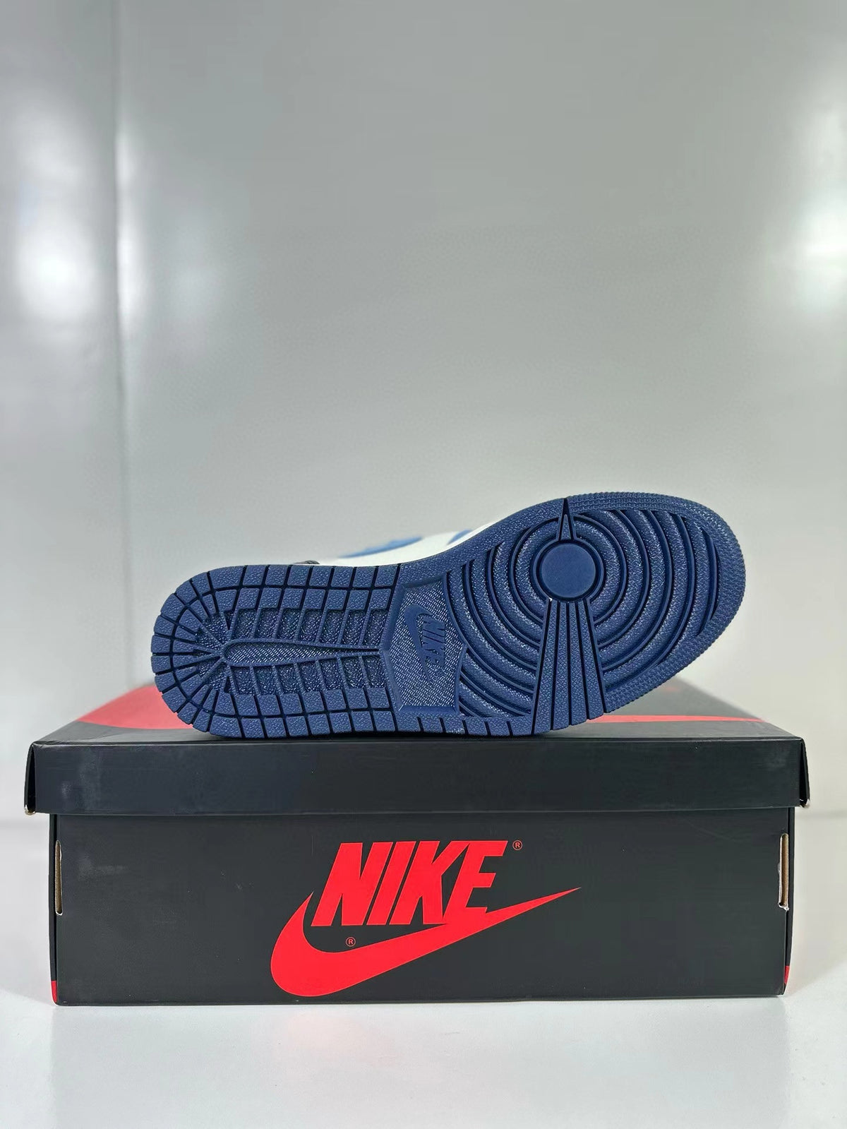 View of the dark navy outsole with circular tread pattern
