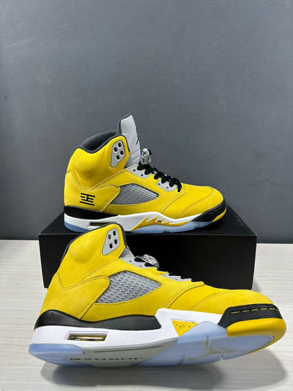 Pair of yellow mid-top sneakers shown from side and outsole angles.