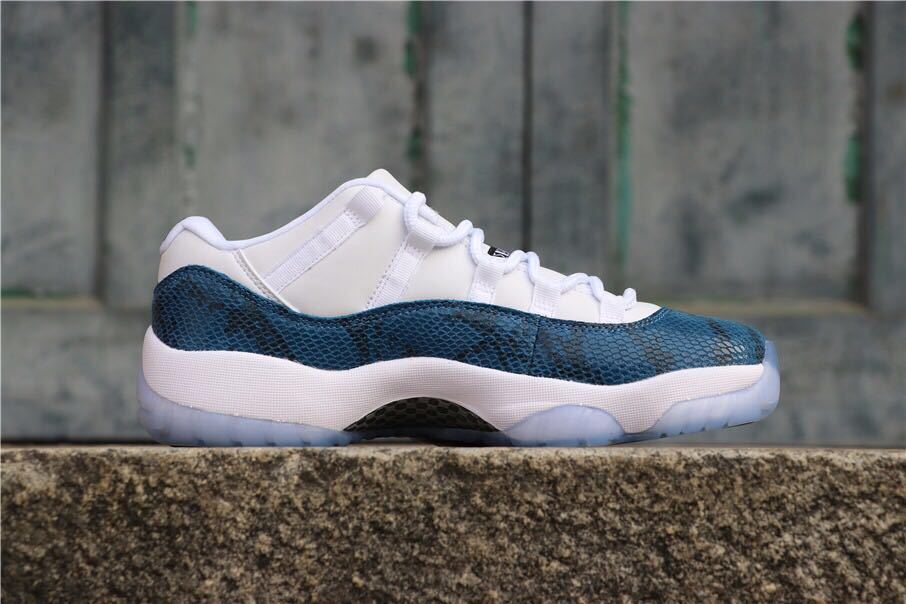 Side profile showing the navy patterned upper, white midsole, and low-top silhouette.