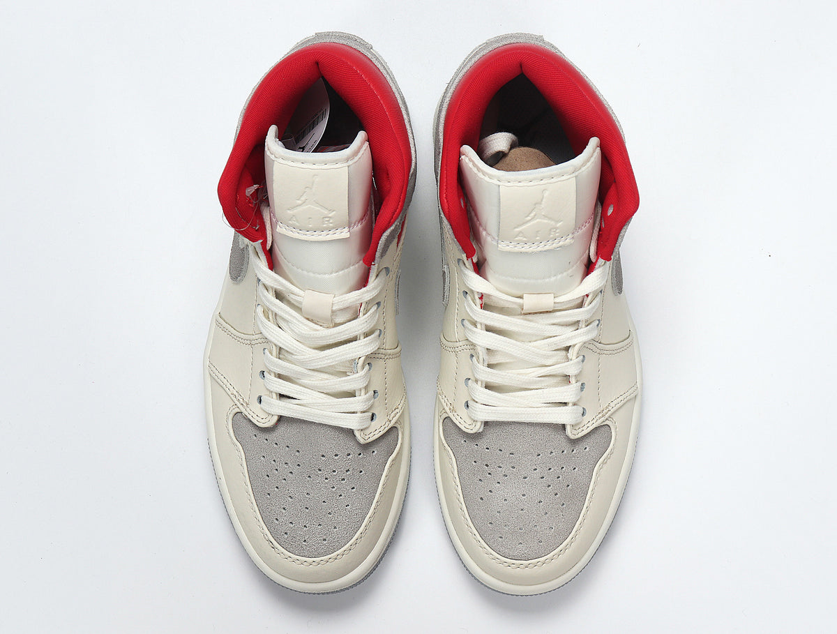 Top view of a pair of grey, white and red high-top sneakers with white laces.