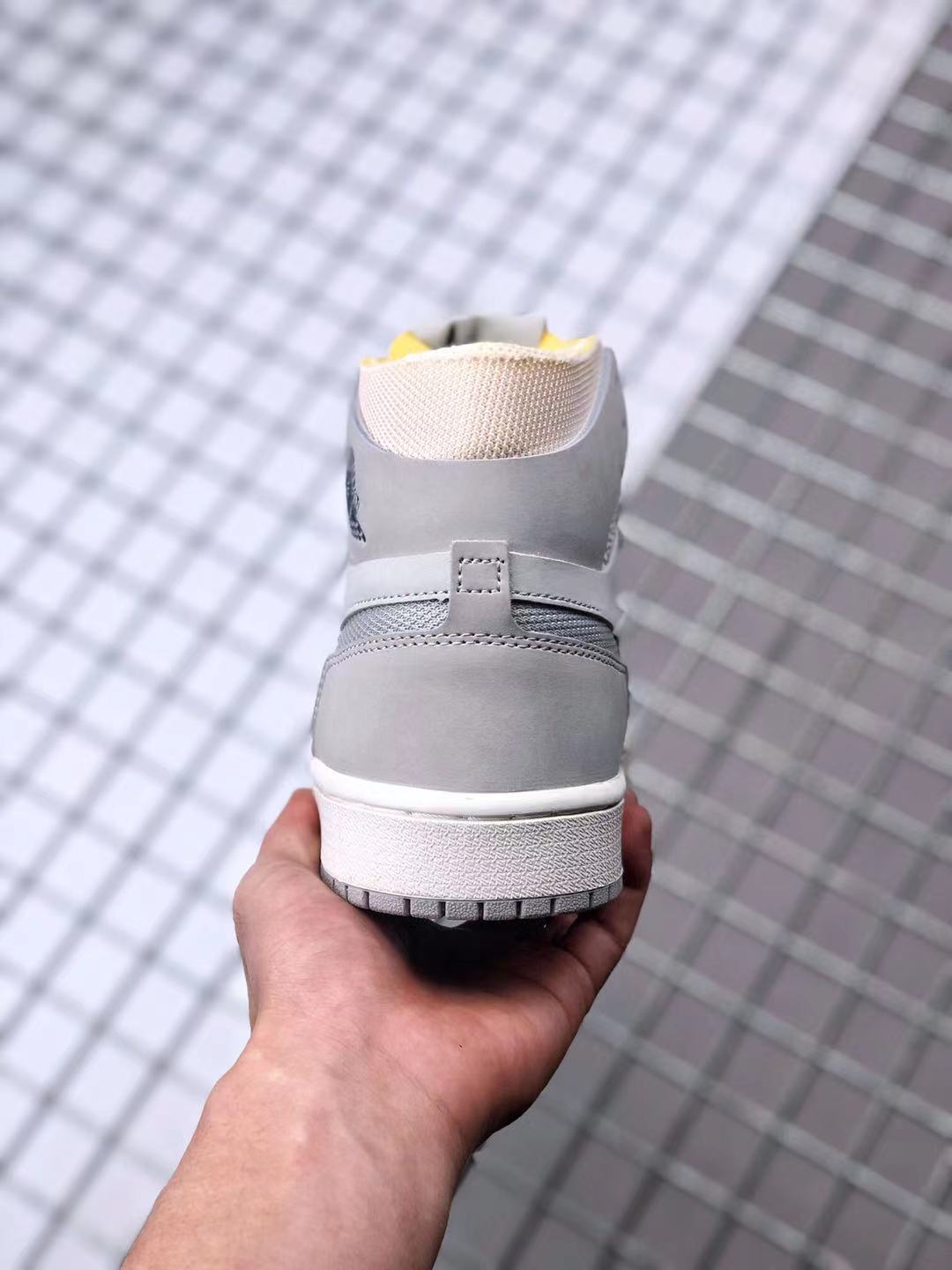 Rear view of the gray high-top sneaker showing the padded collar, heel panel, and outsole edge.