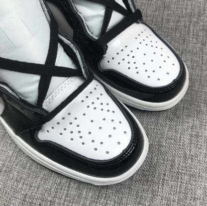 Close-up of the white perforated toe box and black overlay.
