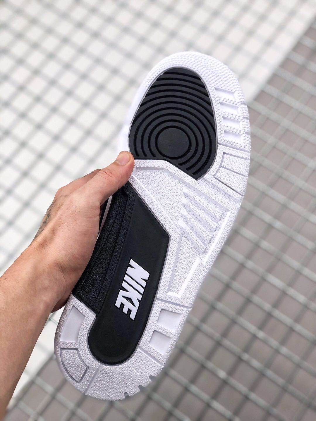 Outsole view showing the black circular traction section and white tread pattern.