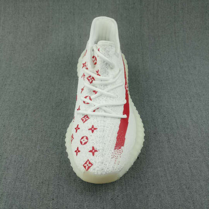 Top-down view showing the white laces, red printed upper details, red side stripe, and ribbed outsole edge.