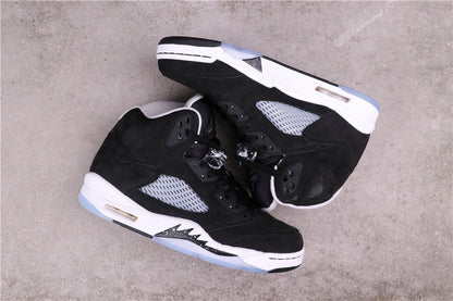 Pair of black and white sneakers arranged on their sides to show the lateral panels and midsoles.