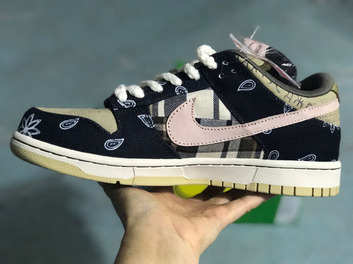 Outer side profile showing the low-top shape, dark patterned upper, contrasting Swoosh, and beige outsole.