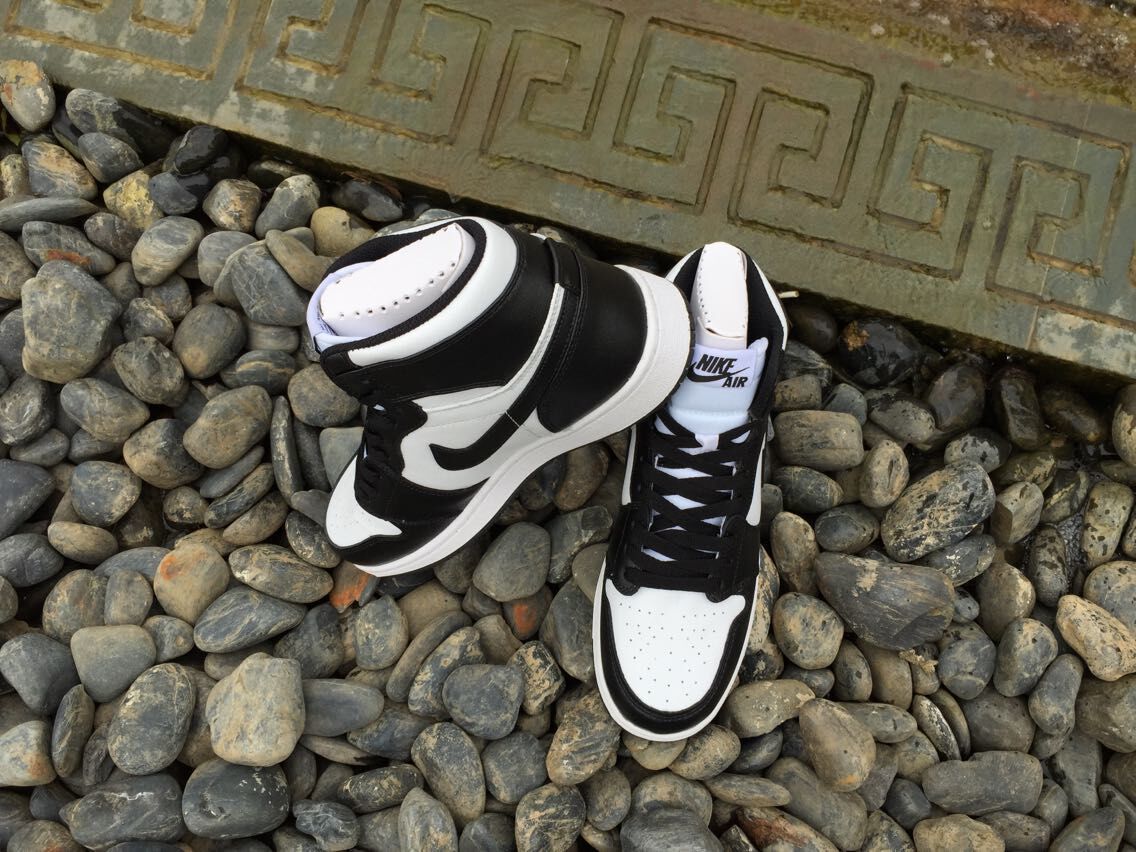 Angled view of the pair showing the high-top profile, padded collars, black laces, and white toe areas.