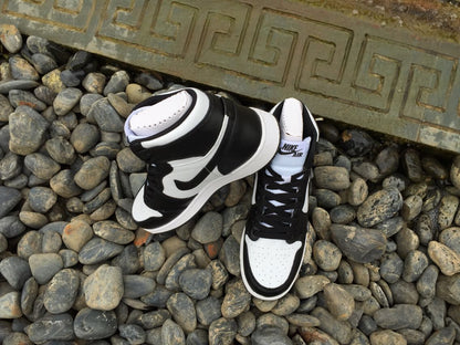 Angled view of the pair showing the high-top profile, padded collars, black laces, and white toe areas.