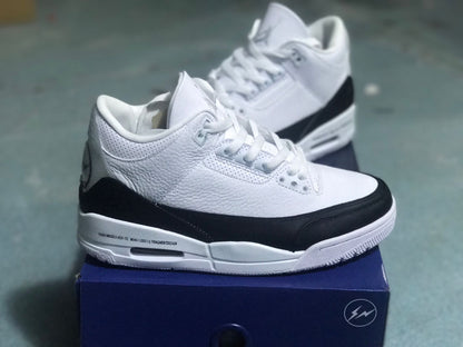 Side view of a white and black Jordan 3 sneaker displayed on its box.