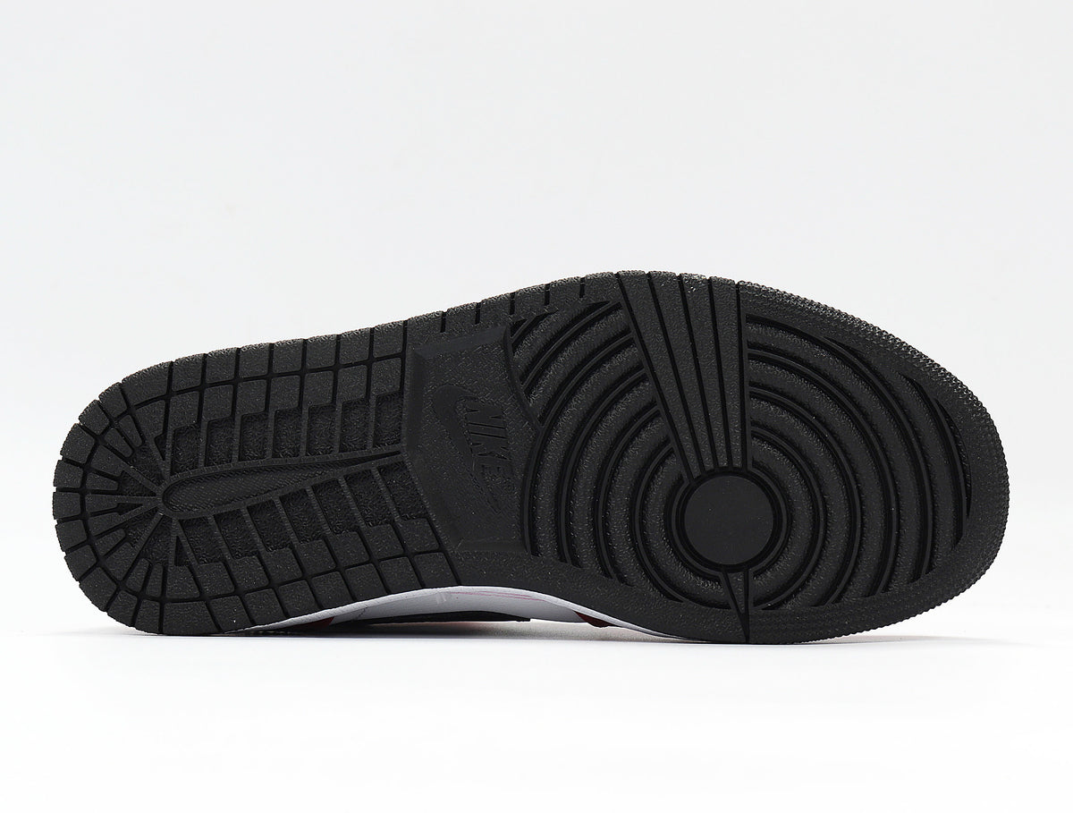 Close view of the black rubber outsole with circular and rectangular traction grooves