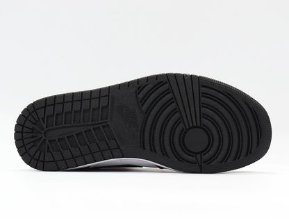 Close view of the black rubber outsole with circular and rectangular traction grooves