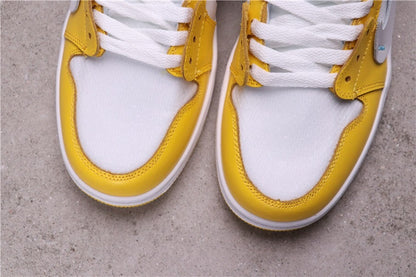 Close-up of the white perforated toe boxes framed by yellow overlays.