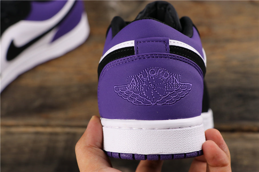 Rear view showing the purple heel panels, embossed winged basketball logo, black collar accents, and white midsoles.