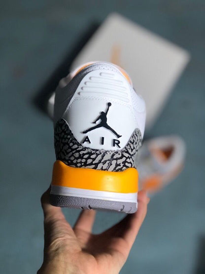 Rear view of the sneaker with elephant-print heel panel and orange midsole accent.