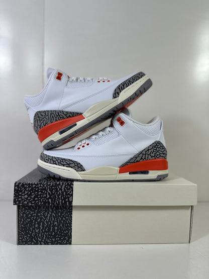 Pair of white, red, and grey Jordan Air Jordan 3 sneakers displayed on a shoebox.