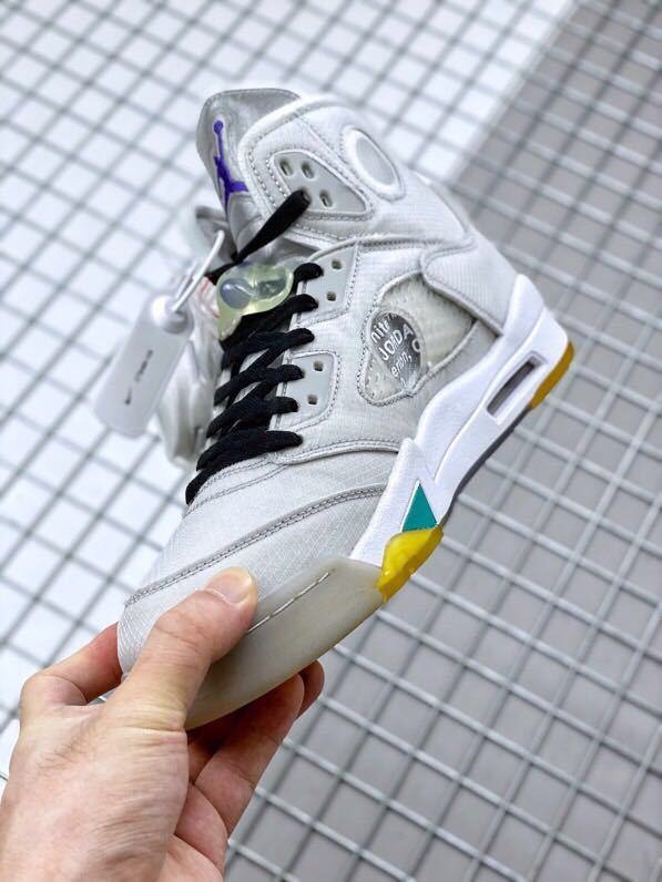 Side close-up showing black laces, translucent panels, grey overlays, and a visible air window.