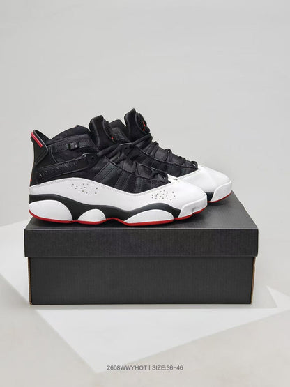 Pair of black, white, and red high-top sneakers displayed on a black shoebox.