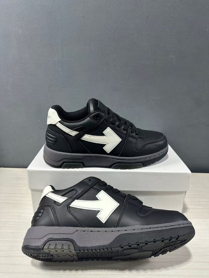Pair of black and white low-top sneakers shown from side and outsole angles.