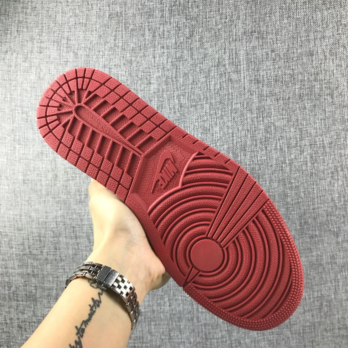 Close-up of the red outsole tread on an Air Jordan 1 sneaker