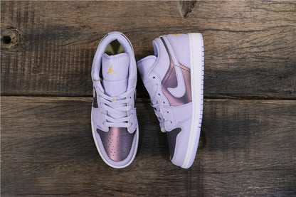 Top view of the purple low-top sneakers showing lace-up fronts, dark panels, metallic purple toe sections, and white soles.