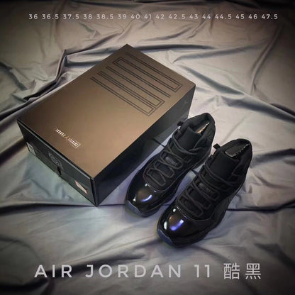 Black Air Jordan 11 sneakers beside a presentation box with a visible size list from 36 to 47.5.