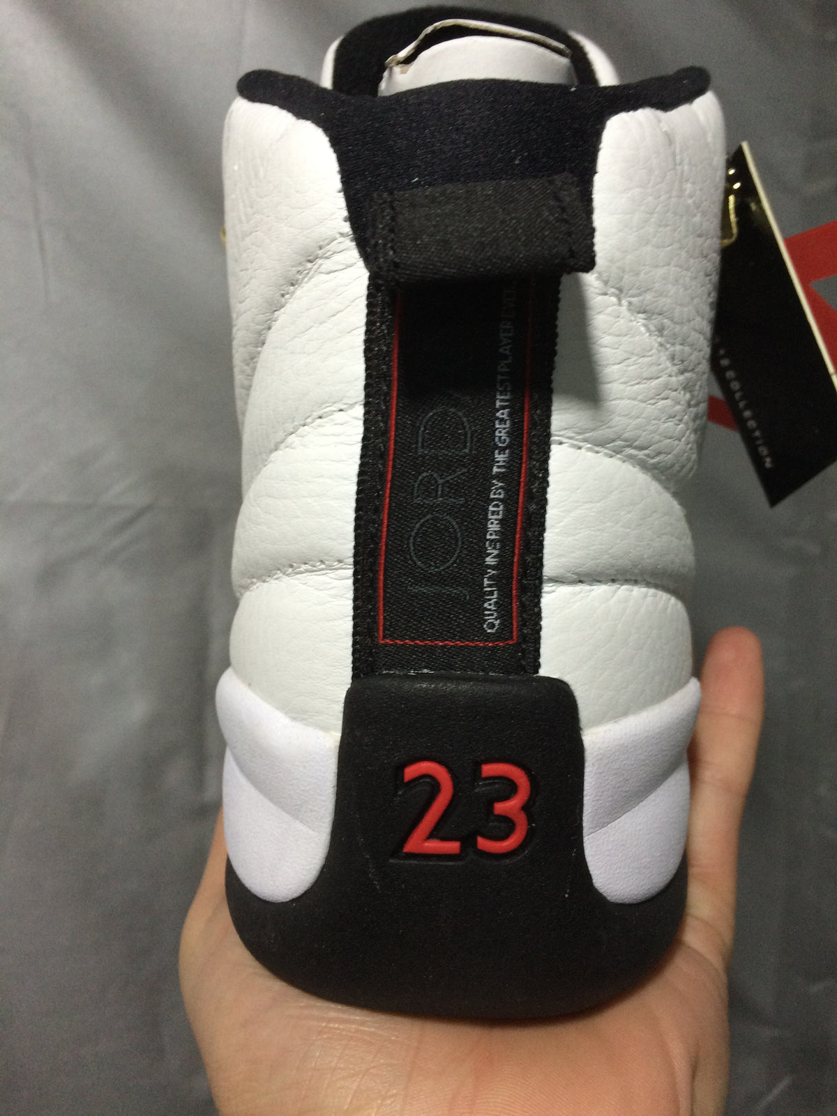 Rear close-up showing the black pull tab, heel branding panel, and red 23 graphic.