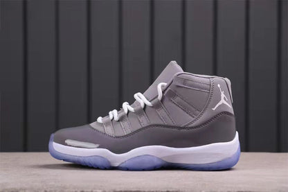 Side profile highlighting the grey upper, white laces, white midsole, and translucent blue outsole.