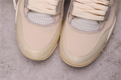 Close-up of the cream sneaker toe boxes, textured front overlays, stitching, and translucent mesh sections.