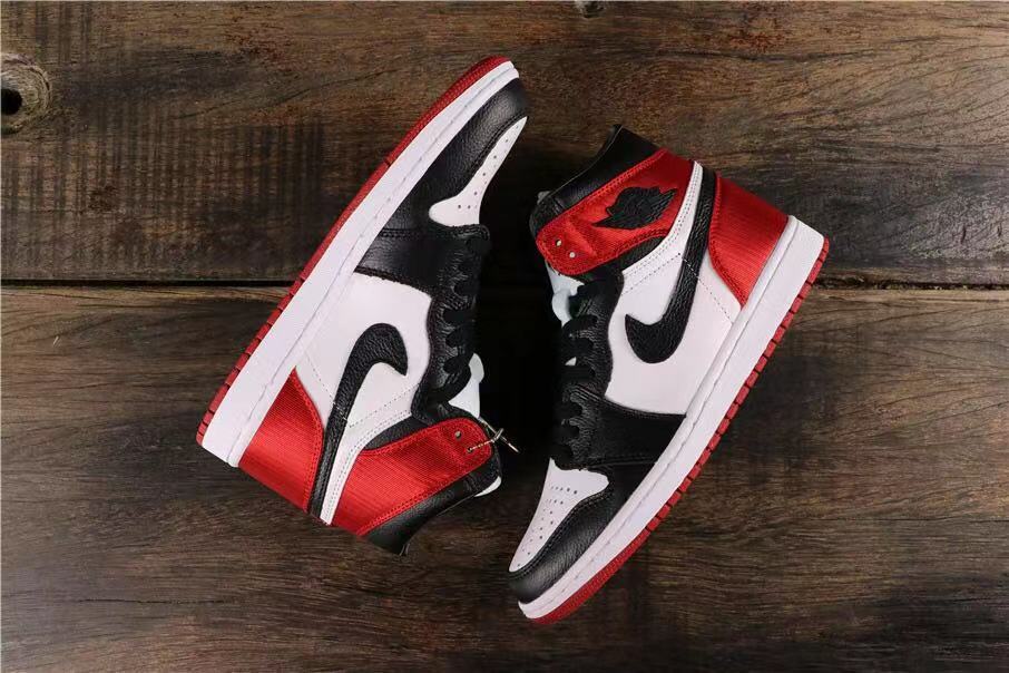 Top-down view of the pair showing black, white, and red high-top sneakers.