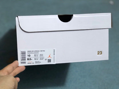 White shoe box showing a Jordan 4 Retro label with product code AQ9129-200 and a photographed EU 42 size marking.
