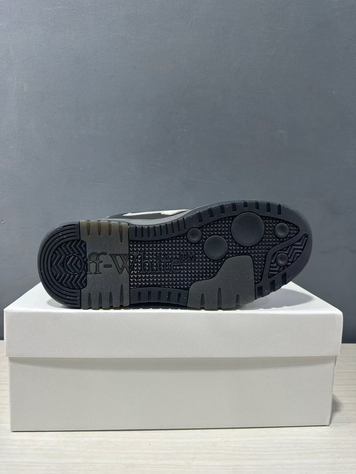 Underside view showing the patterned black rubber outsole and Off-White branding.