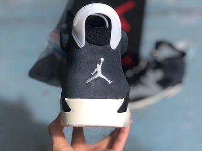 Rear view of the sneaker showing the white Jumpman logo, black heel panel, and white pull tab.