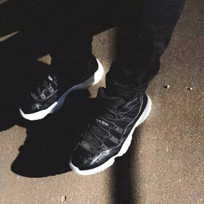 Overhead lifestyle view of the sneakers being worn outdoors, highlighting the reflective-looking silver-black toe areas.